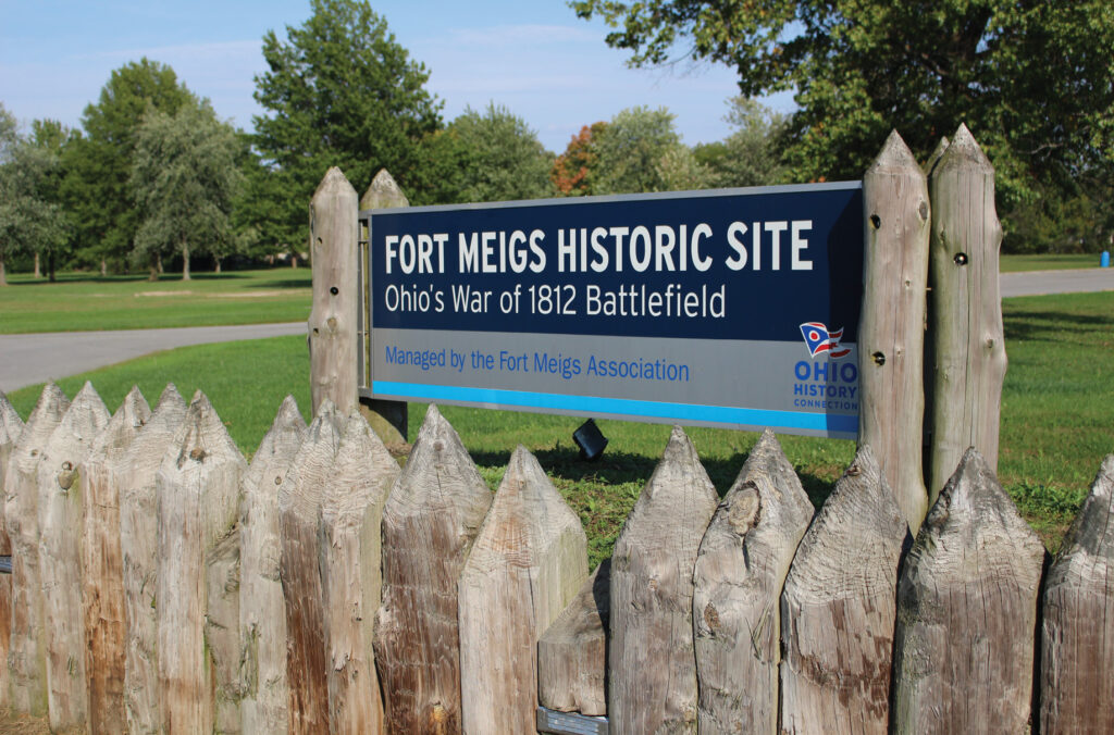 Blue and gray sign that reads "Fort Meigs Historic Site, Ohio's War of 1812 Battlefield"