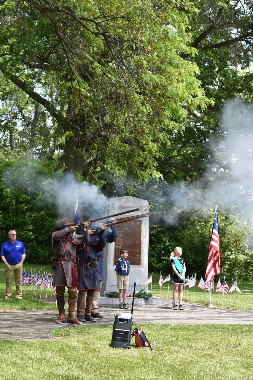 men giving musket salute