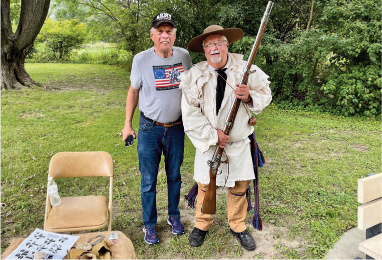 man holding frontier-era firearm