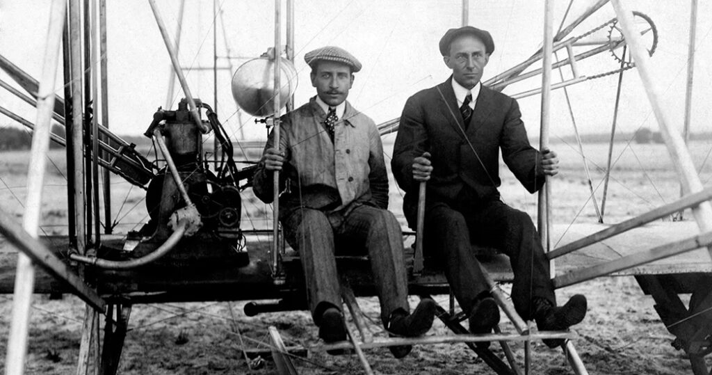 photograph of the wright brothers in an early aircraft